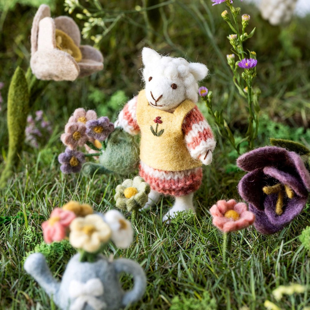 Handmade sheep in garden with felt flowers